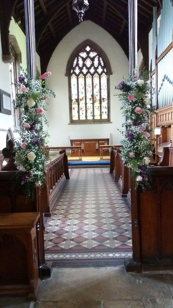Church interior wedding flowers in pink and cream